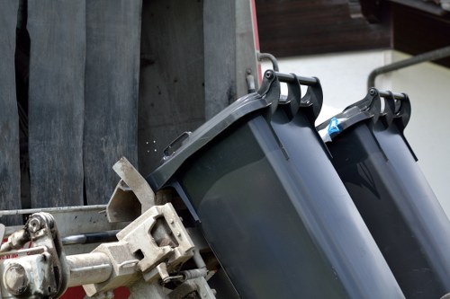 Workers handling furniture for disposal in Stratford